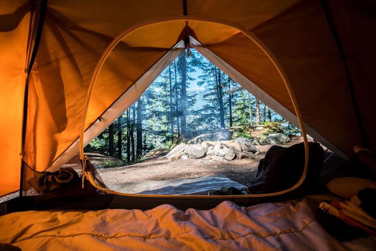 Camping tents by a lake at sunset — high-speed internet even in the wild